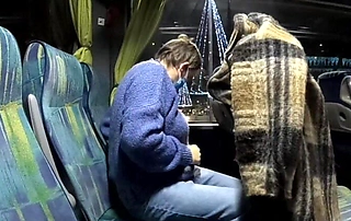 MILF masturbates crossed legs in night bus